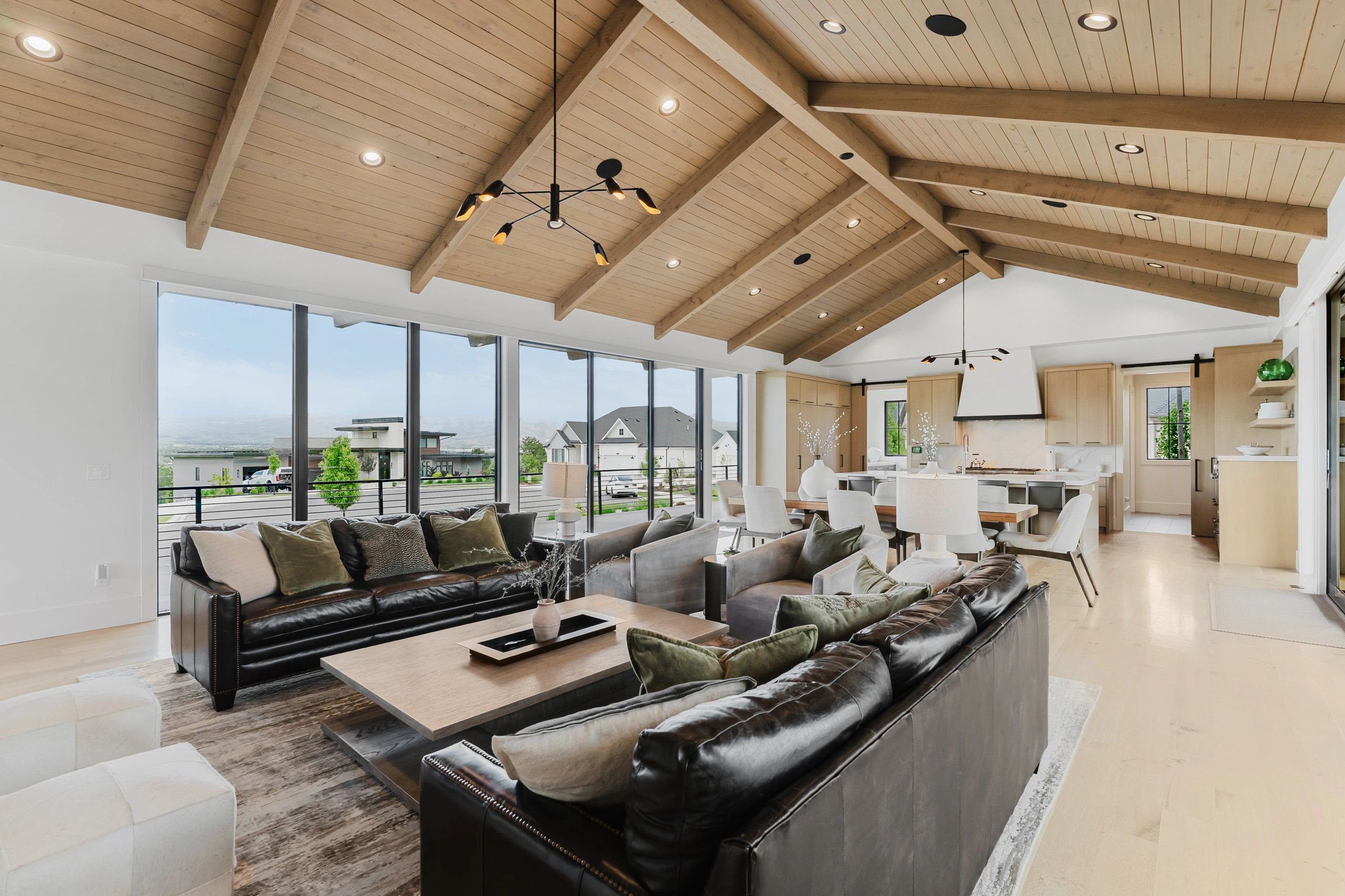 Light filled living room with exposed timber ceilings, photographed by Tidwell Visuals